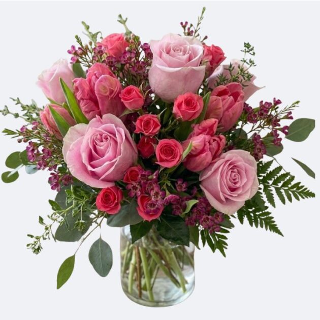 Pink Roses and Tulips Hand-Tied Bouquet 1 A beautiful Pink Roses and Tulips Bouquet arranged in a glass vase with lush greenery.