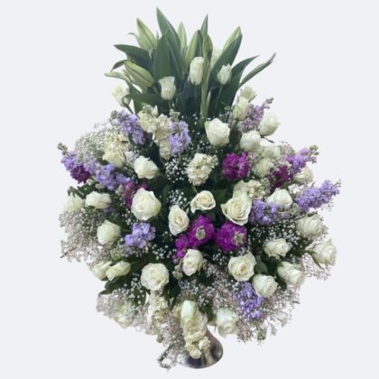 White and Purple Flower Arrangements showcasing a stunning blend of fresh white roses, towering lilies, and deep violet/lavender stock flowers.