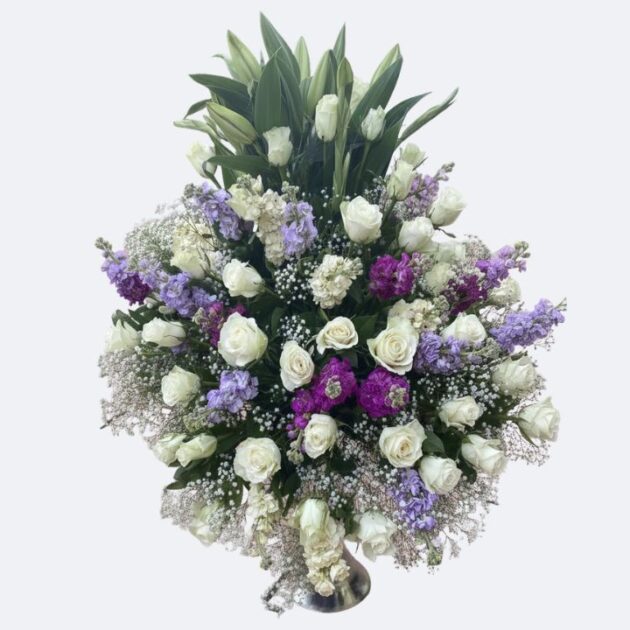 White and Purple Flower Arrangements showcasing a stunning blend of fresh white roses, towering lilies, and deep violet/lavender stock flowers.