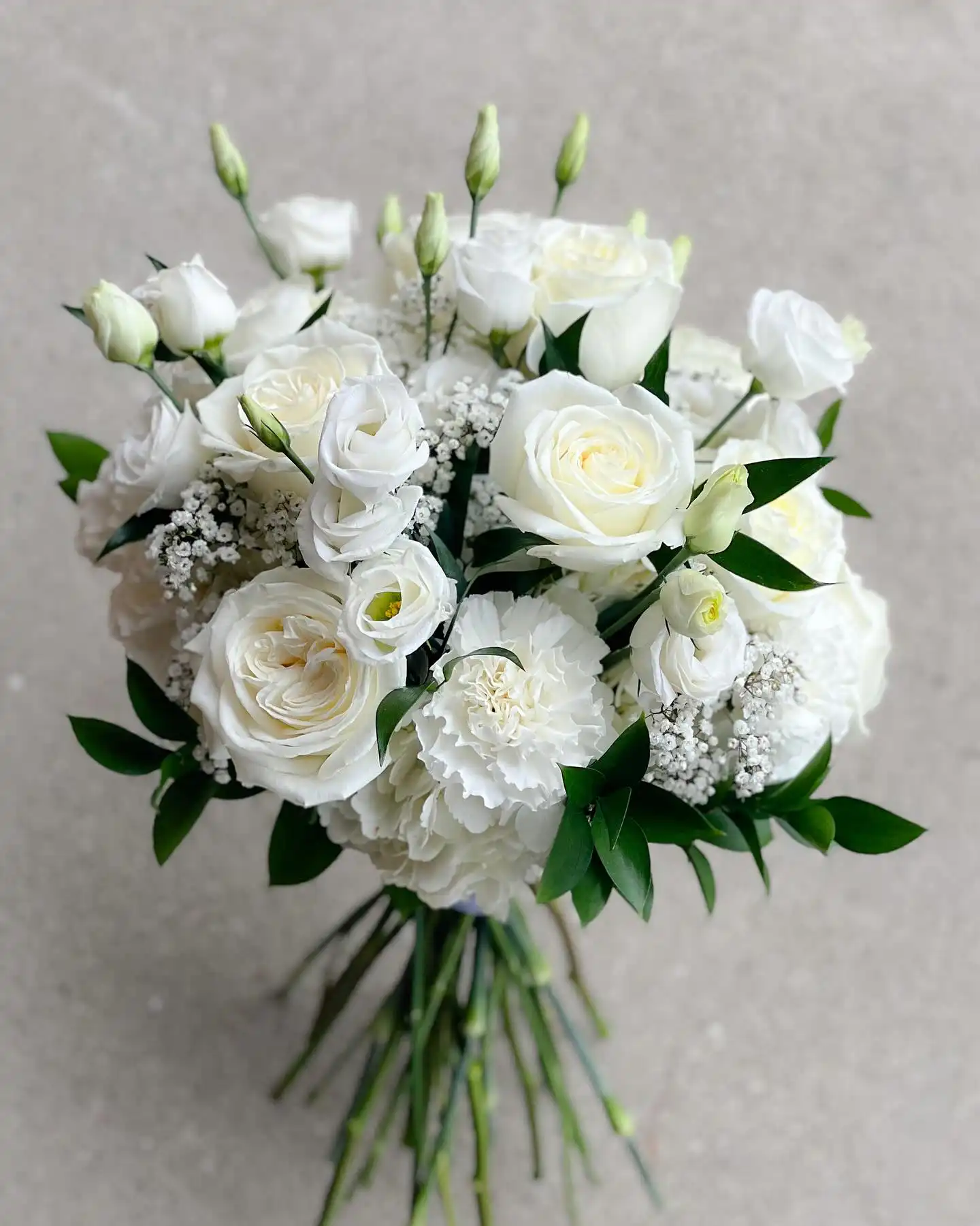 Pure White Carnation and Rose Elegance Bouquet 1 A stunning white carnation and rose bouquet arranged with fresh greenery for an elegant look.