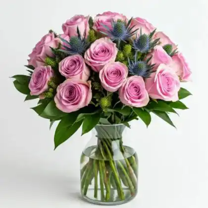 A beautiful pink rose and thistle bouquet arranged with fresh greenery in a classic style.