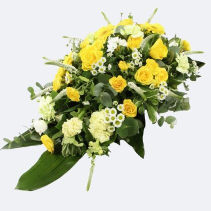 A vibrant Funeral Coffin Spray featuring premium yellow roses, cream carnations, and lush greenery for a memorial service.