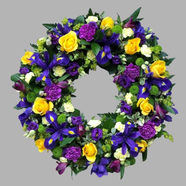 Elegant Yellow and Blue Wreath for a funeral, featuring vibrant yellow roses and soft blue hydrangeas, symbolizing lasting compassion.