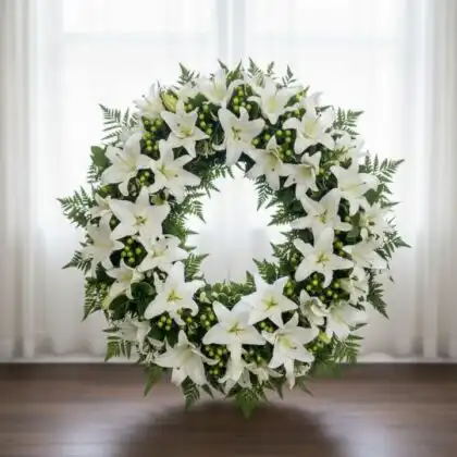 A peaceful Eternal Serenity white lily and rose flower wreath for funeral service, symbolizing remembrance and grace.
