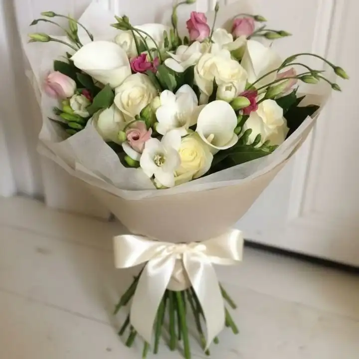 Pure Serenity: Calla Lily & White Rose Luxury Bouquet 1 A handcrafted calla lilies and white roses bouquet elegantly wrapped in craft paper with a silk ribbon.