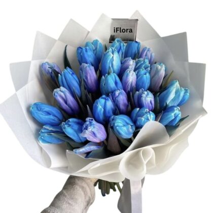 A vibrant Blue Tulips Bouquet wrapped in elegant white textured paper.