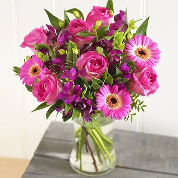 Radiant Pink Rose & Gerbera Bouquet with Lily 1 A vibrant bouquet featuring a pink gerbera rose paired with elegant lilies in a decorative arrangement.