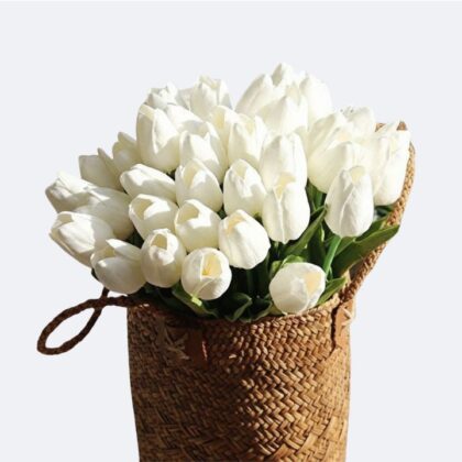 A beautiful arrangement of white Tulip Flower Basket in a rustic woven bag.