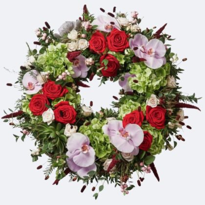 Luxury Sympathy Funeral Wreaths crafted with vibrant red roses, large pink Phalaenopsis orchids, and lush green hydrangeas for a distinguished memorial.