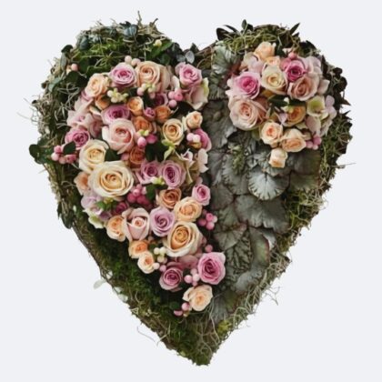 Love Heart Flowers for Funeral: A beautiful arrangement of pink and cream roses on a moss heart wreath.