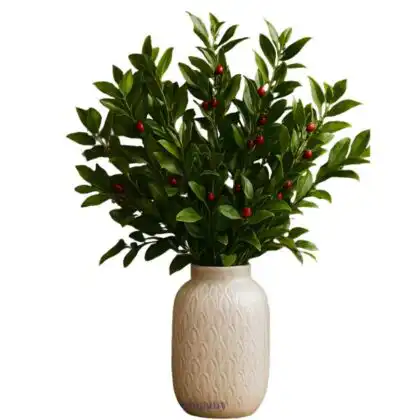 A beautiful Fresh Green Christmas Foliage Arrangement in a textured cream vase with bright red berries.