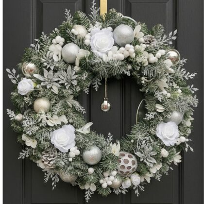 A high-end, sparkling Luxury winter frost Christmas wreath featuring frosted silver pine needles, white berries, and delicate crystal accents, displayed on a dark surface.