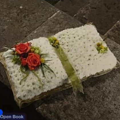 Open Book Funeral Tribute with white flowers and red roses.