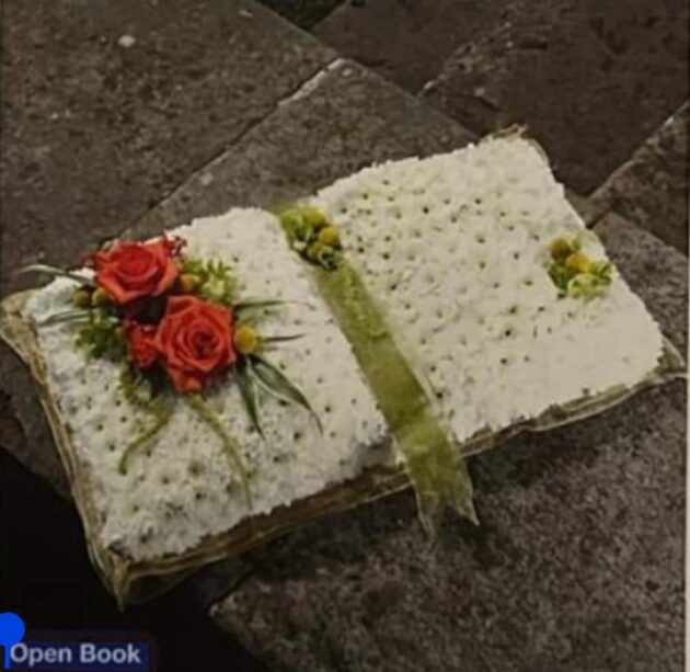 Open Book Funeral Tribute with white flowers and red roses.