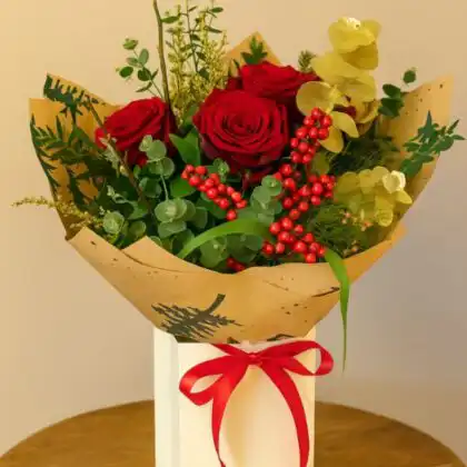 Close-up of a vibrant red Christmas rose arrangement ready for same-day delivery