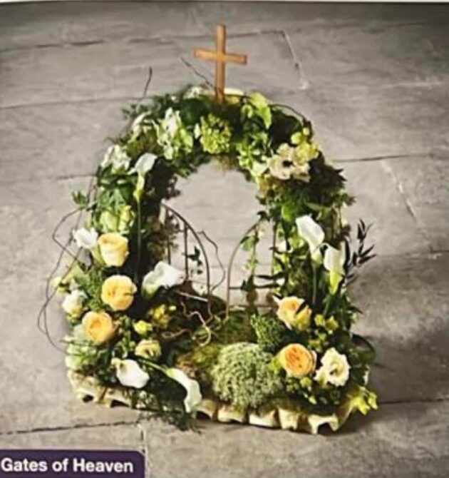 Gates of Heaven 1 Gates of Heaven floral tribute with a cross, white lilies, and yellow roses.