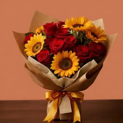 Vibrant sunflower and rose bouquet arranged with fresh greenery in a stylish floral display.